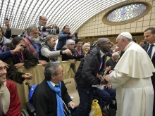 A man identified by the French newspaper La Croix as Emmanuel Abayisenga greets Pope Francis at the Vatican on Nov. 11, 2016.